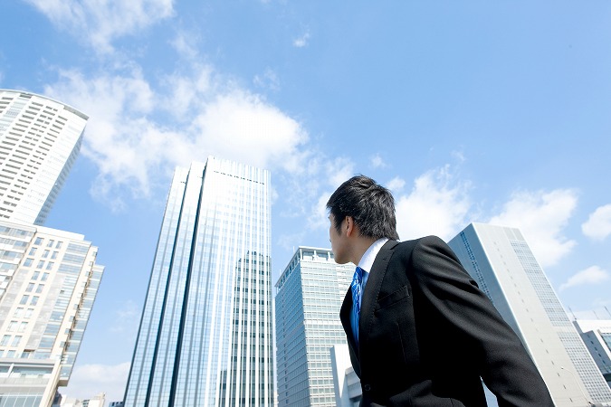 ビルを見上げる社会人